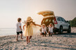 © Garun Studios - Asian family vacation holiday, Happy family running on the beach in the sunset..Children are running to their parents behind cars.Holiday and travel family concept, Summer vacations.