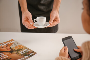 Poster - Barista bringing hot espresso for visitor in cafe