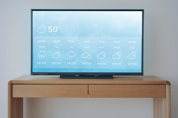 smart tv with weather forecast on wooden stand