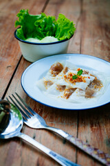 Selective focus of Thai steamed rice-skin dumplings or khao kriap pak maw is tow popular and unique Thai street food snacks ,
thai style dessert on wooden