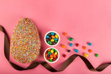 Wall Mural - Easter. Composition with chocolate Easter eggs on pink background, space for text.