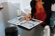 © Johnér - Woman looking at estate agency catalog