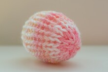 Easter Egg Decoration In Pastel Spring Colors. Pink White Creme Yellow Colorful Yarn Texture. Shallow Depth Of Focus, Light Background. Crafts And Arts, Homemade Crochet Figures, Hobby Activity.