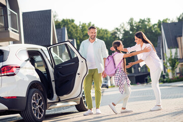 Canvas Print - Photo portrait of father opening car door for daughter to come out and hug mother outdoors on street in summer