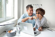 © epiximages - Online shopping concept. Dad and son using laptop for online shopping during corona crisis.