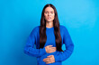 © deagreez - Portrait of brunette sad lady hold stomach wear blue sweater isolated on bright color background