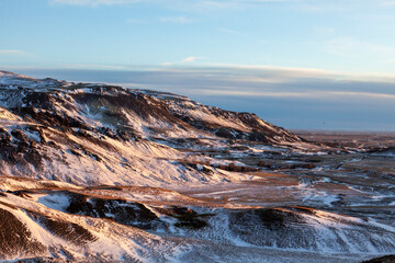 Iceland. Reykjadalur steam valley near Reykjavik, in Iceland with hills covered in white during winter