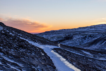 Iceland. Reykjadalur steam valley near Reykjavik, in Iceland with hills covered in white during winter