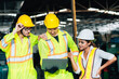 © BigBlues - Work at factory.engineer woman and workers man team working together in safety work wear with white and yellow helmet using laptop computer.in factory workshop industry meeting professional