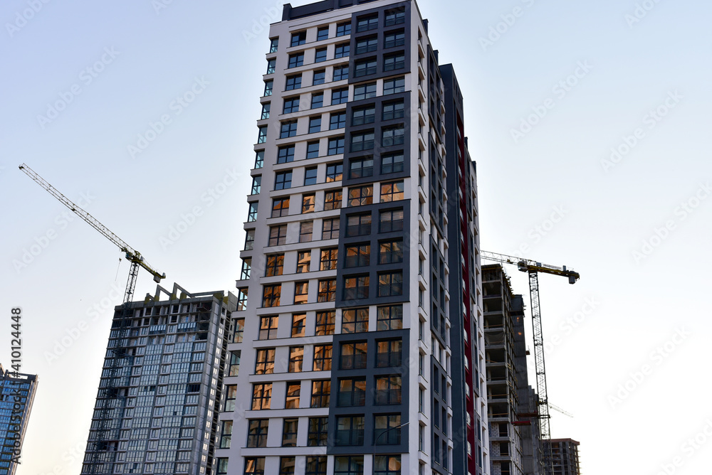 Picture of Tower cranes in action at construction site. Crane the build the high ...