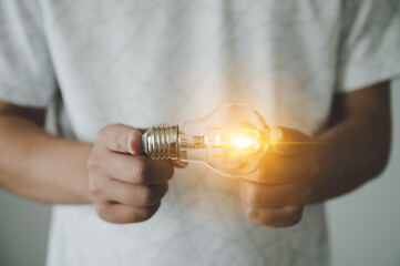 Hand of man holding light bulb. Concept of inspiration creative idea thinking and future technology innovation