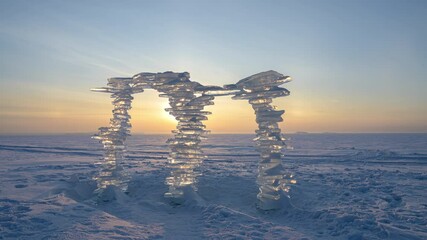 Wall Mural - a sculpture made of pieces of ice against the backdrop of a sunset, on the shore.