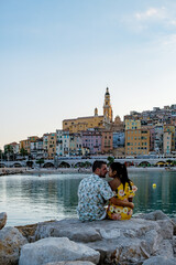 Wall Mural - View on old part of Menton, Provence-Alpes-Cote d'Azur, France Europe during summer, couple men and woman on vacation at Menton France