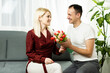 © Angelov - couple in love with a bouquet of tulips are close to each other