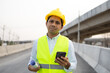 © anut21ng Stock - asian engineer worker using smartphone at construction site