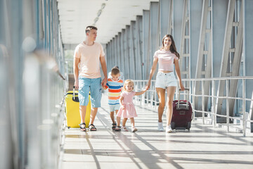 Wall Mural - Happy family in airport departures. People in terminal preparing for the vacation