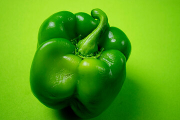 bright green bell pepper on green background