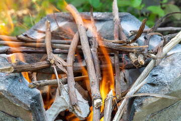 Burning black charcoal in the old stove with paper and dry wood. It produces a lot of smoke when it burns.