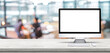 © weedezign - Blank screen desktop computer on wooden table top with blur people working at creative office bokeh background,Mock up for display or montage of design