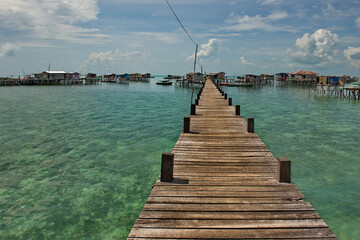 Wall Mural - Semporna. Malaysia. December 01, 2018. Wooden walkways in a sea gypsy village on one of the many reef islands. Only on them you can get to the residential buildings of the village.