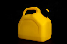 Mockup Of A Yellow Plastic Canister For Car Fuel On A Black Background. Container For Liquids And Hazardous Fuels.