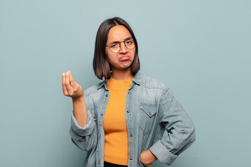 Canvas Print - young hispanic woman making capice or money gesture, telling you to pay your debts!