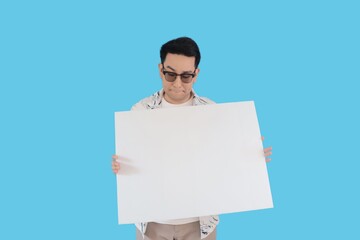 Portrait smiling man in casual shirt holding blank poster.