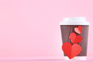 Wall Mural - Red hearts with paper cup on pink background