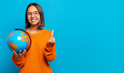 Canvas Print - young hispanic woman smiling proudly and confidently making number one pose triumphantly, feeling like a leader