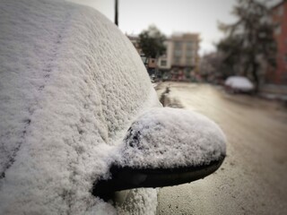 Snowfall.  Winter day.  Snow falling on the car.  Snowflake.