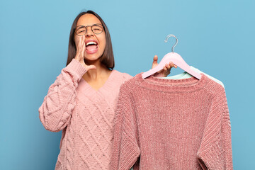 Canvas Print - young hispanic woman feeling happy, excited and positive, giving a big shout out with hands next to mouth, calling out