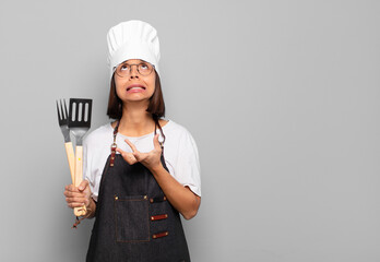 Wall Mural - young hispanic woman looking desperate and frustrated, stressed, unhappy and annoyed, shouting and screaming