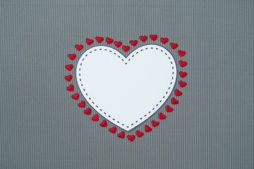 Paper elements in shape of hearts on gray background. Symbols of love for Happy Women's, Mother's, Valentine's Day, birthday greeting card design.