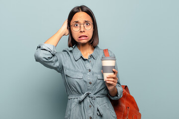 Wall Mural - young hispanic woman feeling stressed, worried, anxious or scared, with hands on head, panicking at mistake