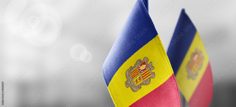 Obraz na płótnie Small national flags of the Andorra on a light blurry background w salonie