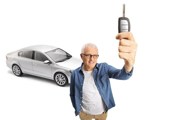 Wall Mural - Mature man with a brand new silver car holding a car key in front of camera