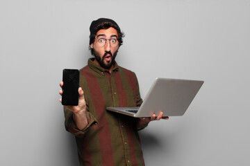 Wall Mural - young bearded man with a laptop