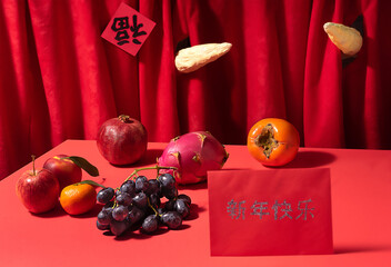 Two ox horns broke through red curtain.  On the table various fresh fruits. On the curtain of Cantonese characters sign Good Fortune. Down red table with red lucky envelope with sign Happy New Year.