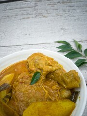 Wall Mural - A bowl of chicken curry with potatoes