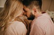 © Look! - Lovely couple in romantic mood poses for close-up portrait. Brunette guy and blonde girl are touching noses