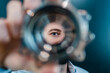 © Daniel Ingold/Westend61 - Male professional's eyes seen through circular machine part in factory