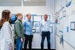 © Daniel Ingold/Westend61 - Business people planning while standing in meeting at office