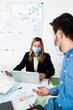 © Giorgio Fochesato/Westend61 - Business people wearing protective masks¬†working in office¬†