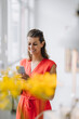 © Gustafsson/Westend61 - Smiling businesswoman using smart phone in office