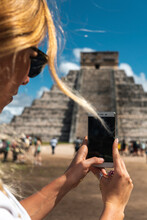 Mexico, Yucatan, Chichen Itza, Hands Of Female Tourist Taking Smart Phone Photos Of Temple Of Kukulcan