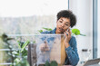 © Uwe Umst√§tter/Westend61 - Woman talking on phone and using transparent display at home