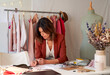 © Veam/Westend61 - Beautiful female fashion professional drawing design on paper at desk in studio
