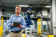 © Daniel Ingold/Westend61 - Mature supervisor holding digital tablet while looking away in industry