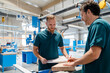 © Daniel Ingold/Westend61 - Two male carpenters working together in production hall