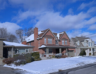 Poster - Suburban Residential neighborhood with single family houses with large front yards on a sunny day in winter